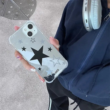 A person holding a phone with a star design on it