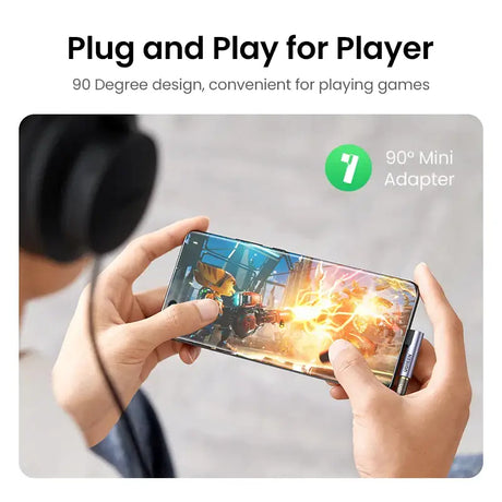 A person holding a phone with a video game on it