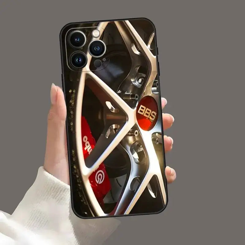 a person holding a phone with a wheel on it