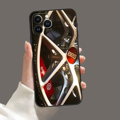 A person holding a phone with a wheel on it