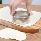 a person is putting a piece of bread into a bowl