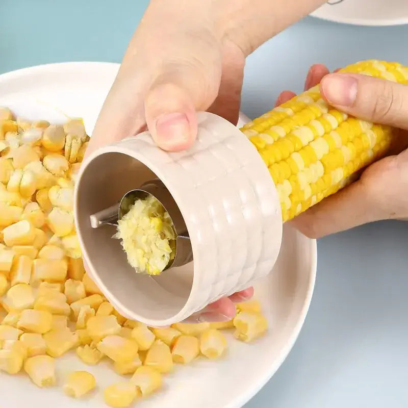 a person is peeling a piece of corn into a bowl