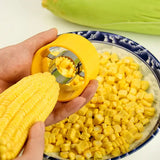 a person is peeling a piece of corn into a bowl