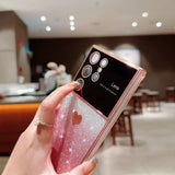 a person holding a pink glitter phone