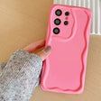 A person holding a pink phone case