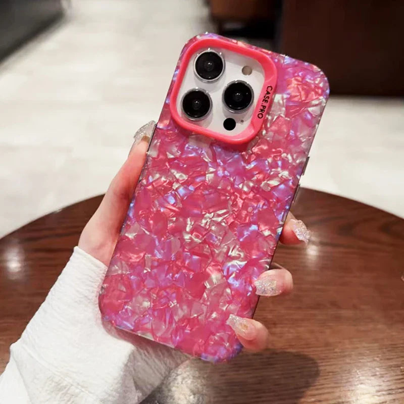 a person holding a pink phone case