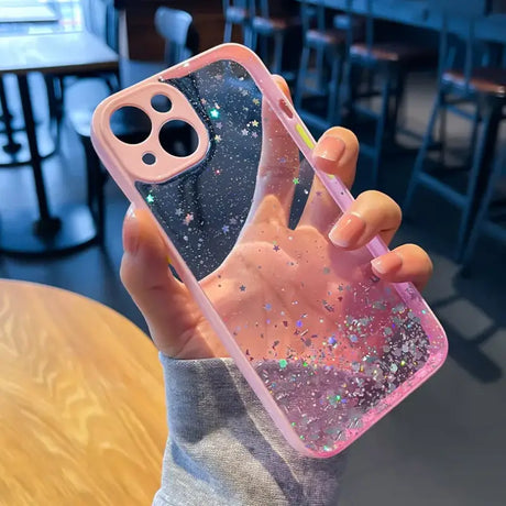 A person holding a pink phone case with glitter