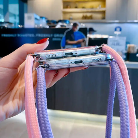 a person holding a pink and silver phone