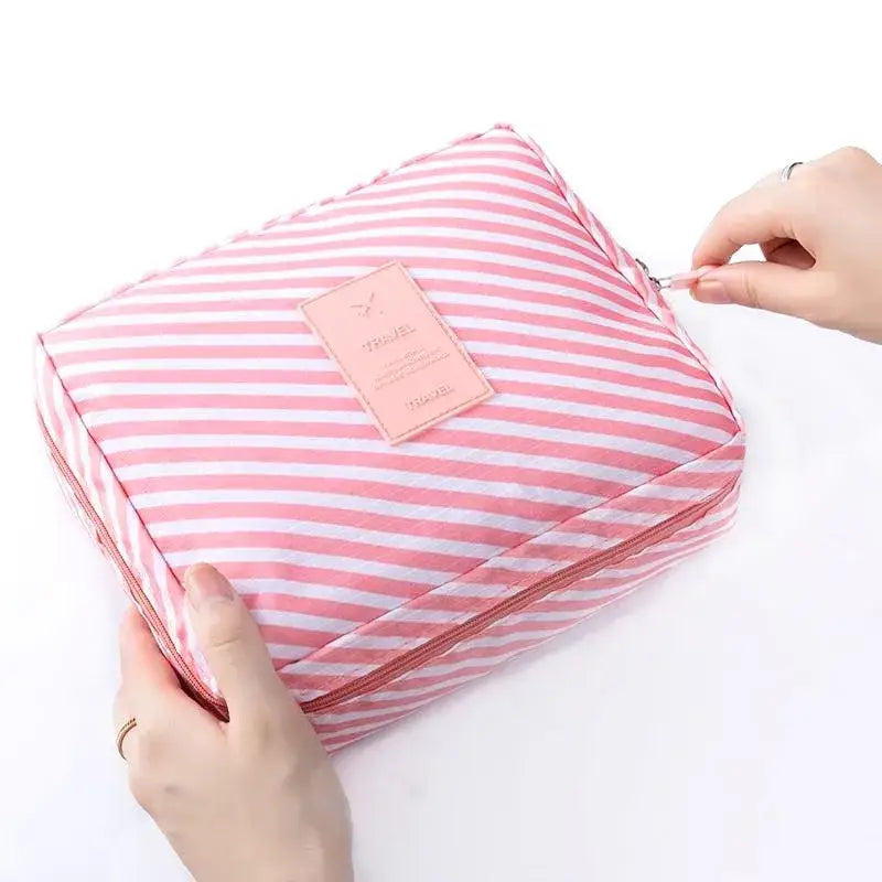 a person holding a pink and white striped bag