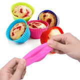 a person is holding a plastic cupcake cutter