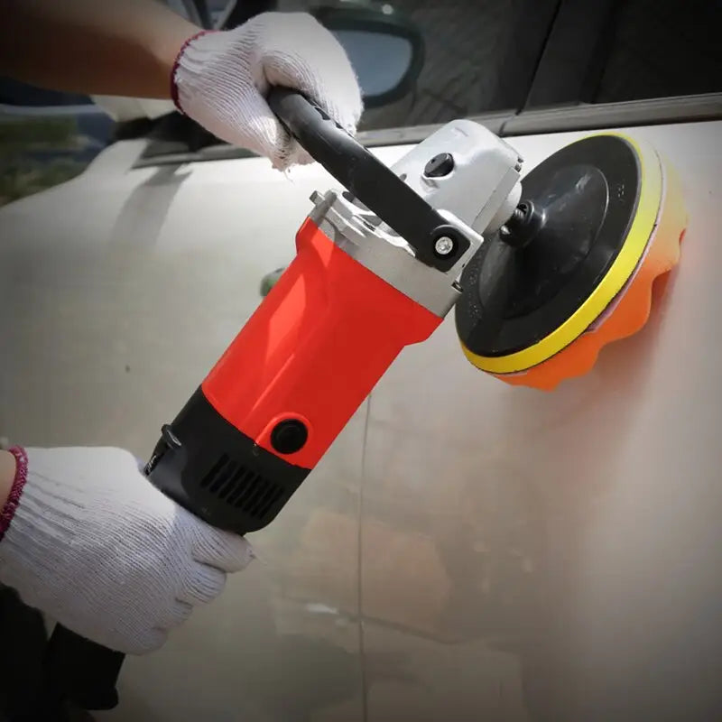 a person using a polisher to polish a car