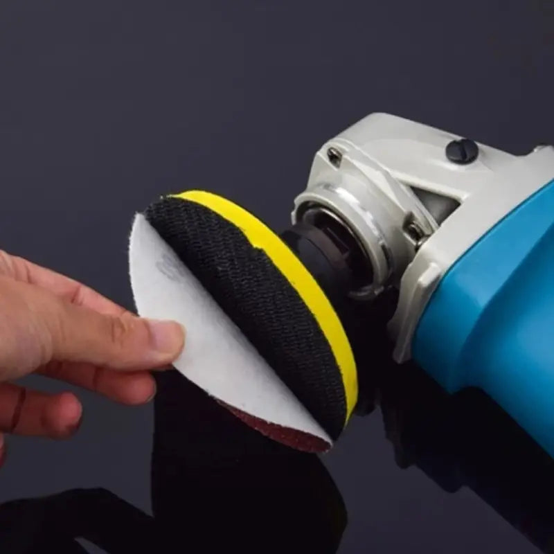 a person using a polisher to polish a surface
