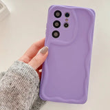 a person holding a purple iphone case