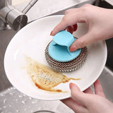 a person is putting a blue cupcake into a white plate