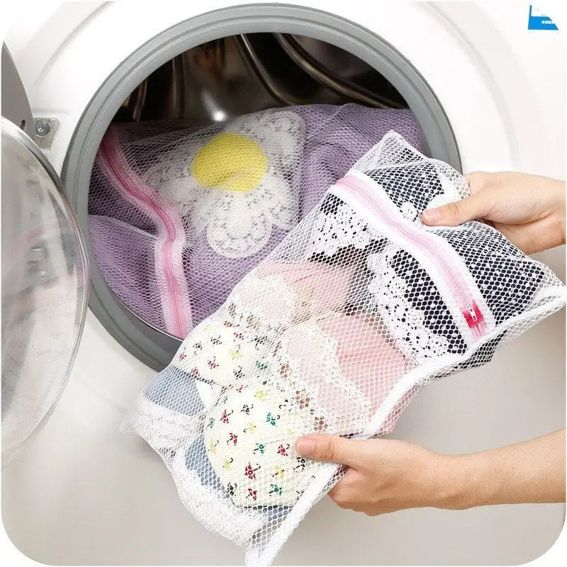 a person putting a laundry bag into a washing machine