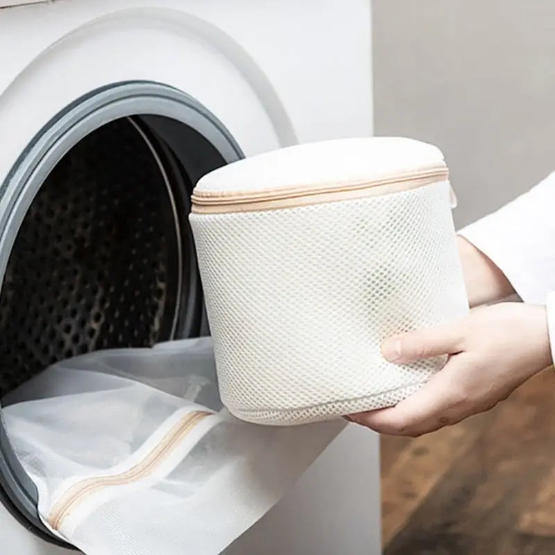 a person putting a paper towel into a washing machine