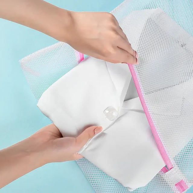 a person putting a piece of plastic mesh to a bag