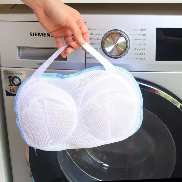 a person putting a white mask on top of a washing machine