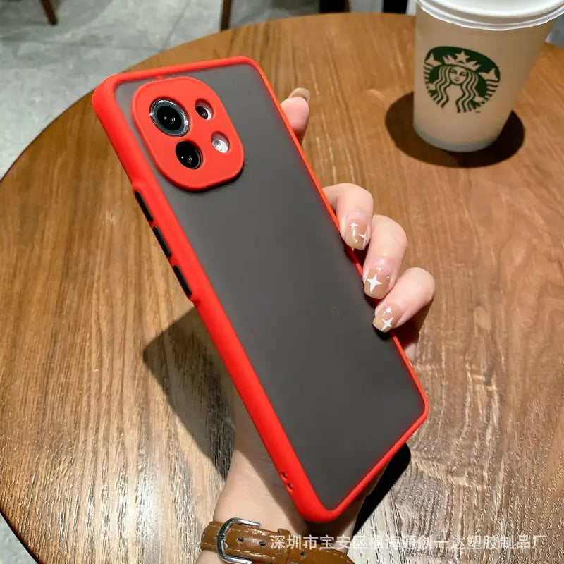 a person holding a red iphone case