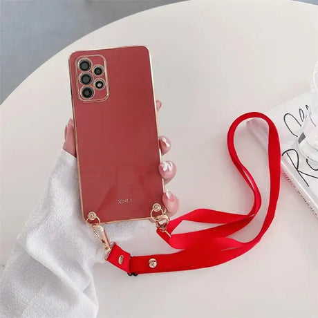 A person holding a red phone case