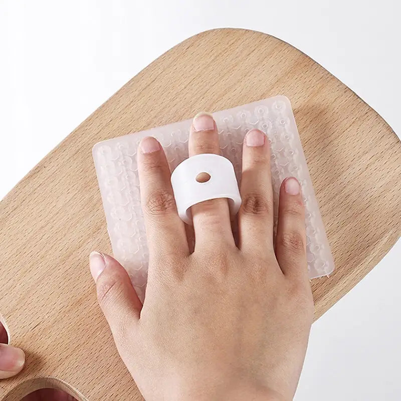 a person using a plastic finger to remove the finger