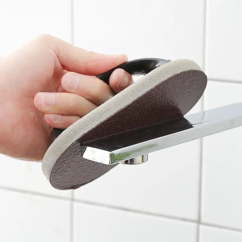 a person using a sponge to clean a shower