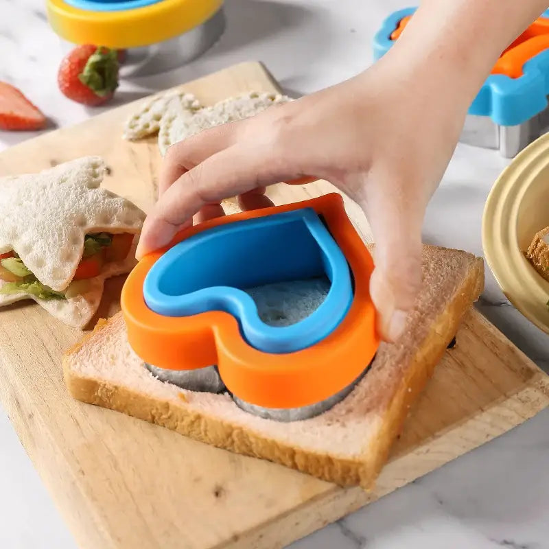 a person cutting a sandwich with a knife