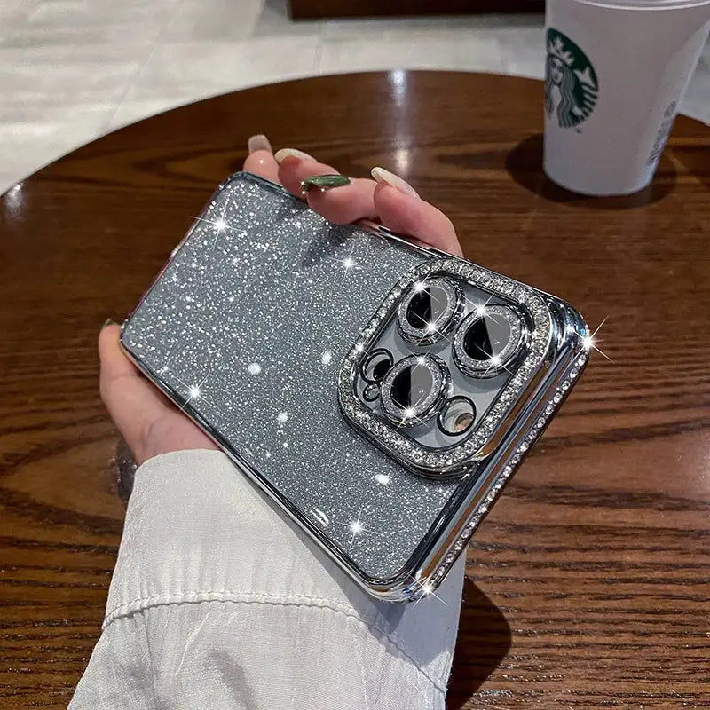 a person holding a silver glitter phone case