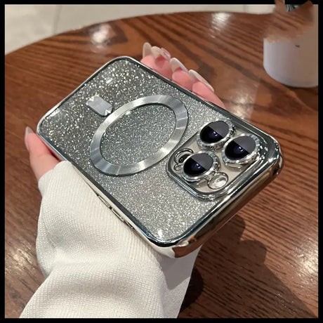 A person holding a silver glitter phone case