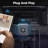 A person using a smartphone to play music on a car dashboard