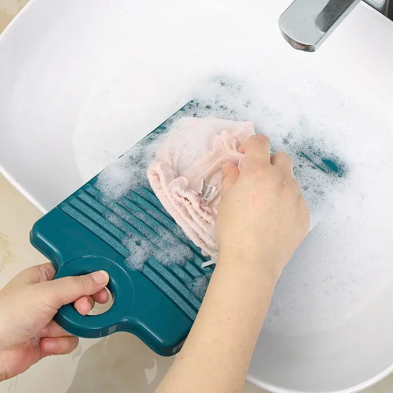 someone using a sponge to clean a sink