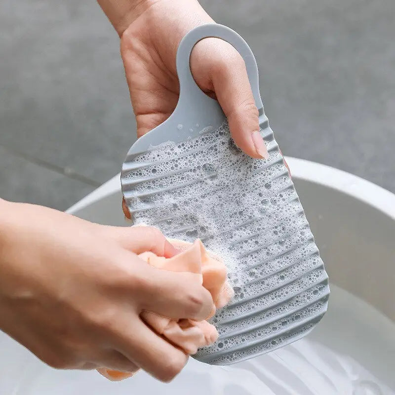 someone using a sponge to clean a sink