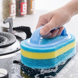 someone using a sponge to clean the stove