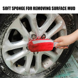 a person using a sponge to remove the rim of a car