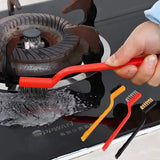 a person using a tool to clean a stove