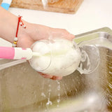 a person washing a bowl with a foam