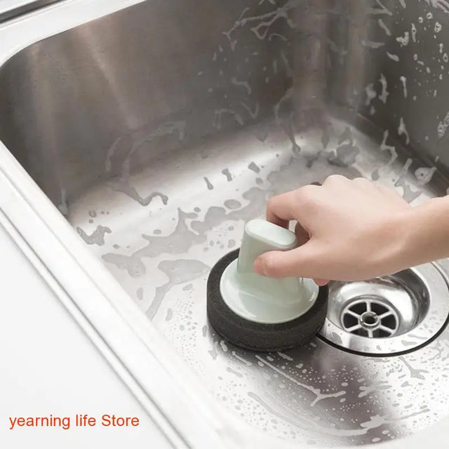 a person washing a sink with a sponge