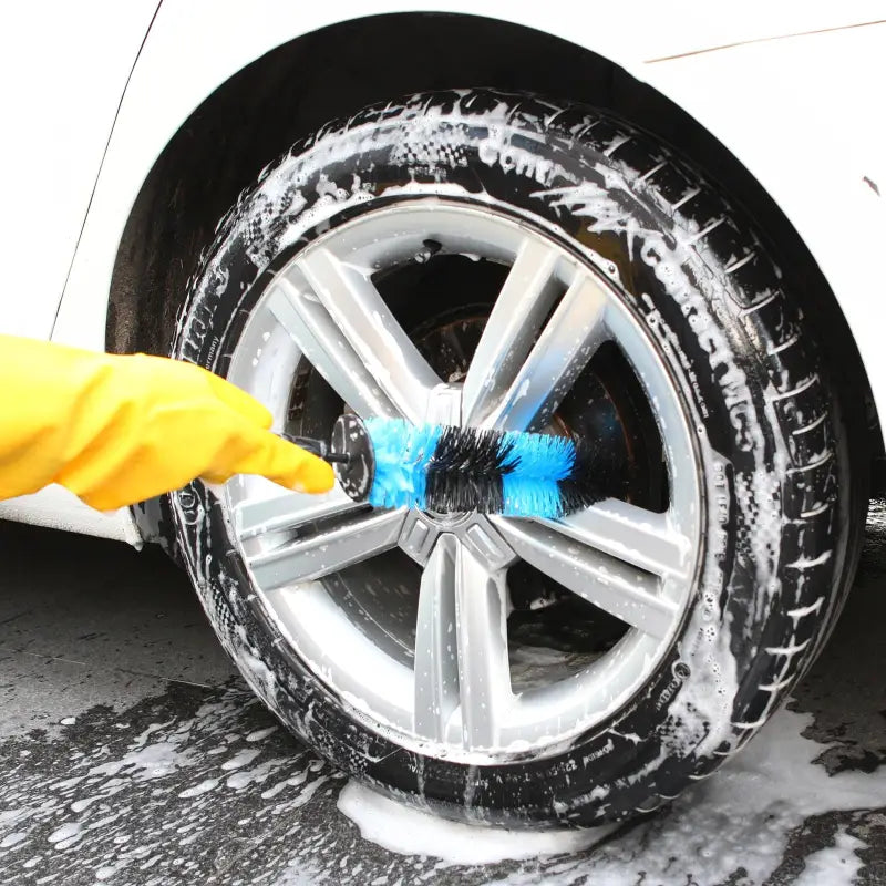 a person washing a car with a sponge