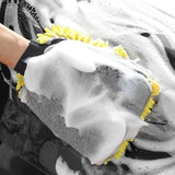 someone cleaning a car with a sponge