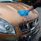 a person washing a car with a sponge