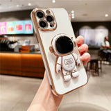 a person holding a white phone case with a gold robot