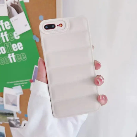 A person holding a white phone case