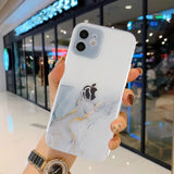 a person holding a white phone case with a marble pattern