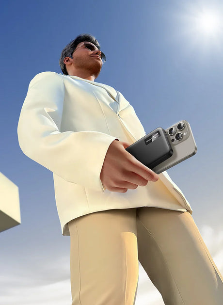 Person wearing a white sweater and light-colored pants holding a smartphone.