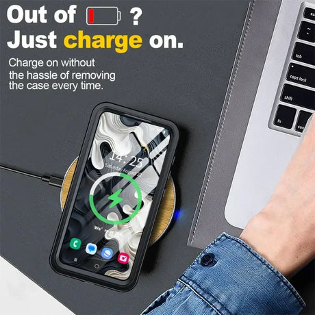 A person using a wireless charger on a laptop