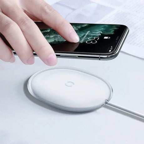 a person using a wireless mouse to mouse on a white surface