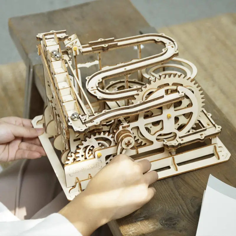 a person working on a wooden clock