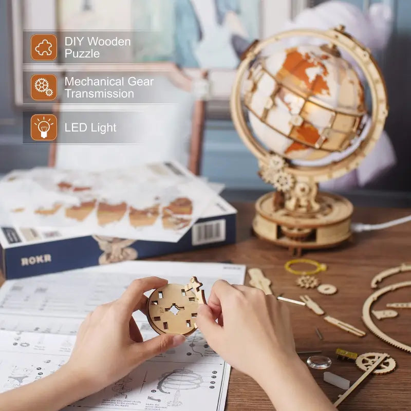 a person is working on a wooden globe