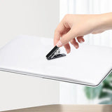 a person using a pen to write on a white paper