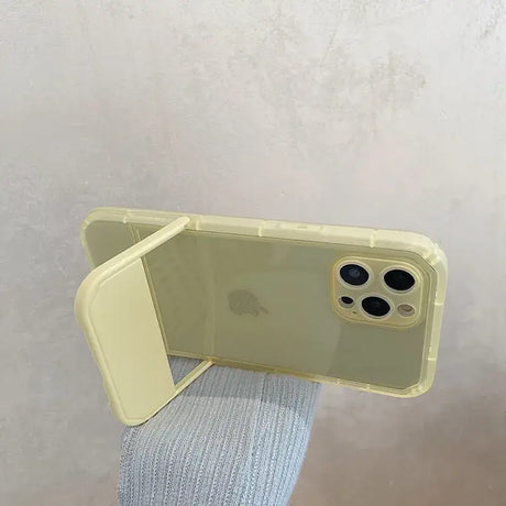 A person holding a yellow iphone case